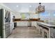 Modern kitchen featuring stainless steel appliances, stone backsplash, and breakfast bar with seating at 9821 Bucknell Ct, Highlands Ranch, CO 80129