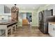 Open kitchen with stainless steel refrigerator and breakfast bar overlooking entry and stairs at 9821 Bucknell Ct, Highlands Ranch, CO 80129