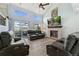 Bright living room with fireplace, vaulted ceiling and sliding glass door to deck at 9821 Bucknell Ct, Highlands Ranch, CO 80129