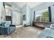 Spacious living room with vaulted ceiling, light blue walls, hardwood floors, and large window at 9821 Bucknell Ct, Highlands Ranch, CO 80129