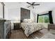 Bedroom with large bed and ornate headboard and dark wood floors at 9821 Bucknell Ct, Highlands Ranch, CO 80129