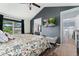 Comfortable main bedroom with large window, ceiling fan, sitting area, and ensuite bath at 9821 Bucknell Ct, Highlands Ranch, CO 80129