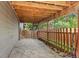 Covered patio area with stone flooring and a wooden fence at 9821 Bucknell Ct, Highlands Ranch, CO 80129