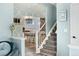 View of the staircase showcasing a modern design, leading to an open kitchen area with bar seating at 9821 Bucknell Ct, Highlands Ranch, CO 80129