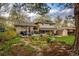 Beautiful backyard with mature trees, lush gardens, patio, and spacious deck perfect for entertaining at 1140 S Dover St, Lakewood, CO 80232