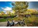 Cozy backyard deck features relaxing chairs and lovely landscaping for peaceful outdoor enjoyment at 1140 S Dover St, Lakewood, CO 80232