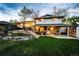 Spacious backyard featuring a lush lawn, inviting patio area, and stylish outdoor seating at 1140 S Dover St, Lakewood, CO 80232