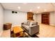 Basement living area with neutral walls, recessed lighting, and built-in wooden cabinets at 1140 S Dover St, Lakewood, CO 80232