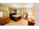 Bedroom with hardwood-style flooring, a light green color scheme, and vintage-style furnishings at 1140 S Dover St, Lakewood, CO 80232