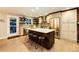 Bright kitchen featuring a large island, stainless steel appliances, and open shelving at 1140 S Dover St, Lakewood, CO 80232