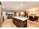 Open kitchen and living area with island, dining space, and comfortable seating at 1140 S Dover St, Lakewood, CO 80232