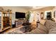 Living room with hardwood-style floors, a modern television, and a neutral-colored sofa at 1140 S Dover St, Lakewood, CO 80232