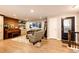 Bright living room features a piano, comfortable seating, and entryway with a decorative glass door at 1140 S Dover St, Lakewood, CO 80232