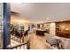 Open concept living space with hardwood floors, a kitchen island, and stairs at 1140 S Dover St, Lakewood, CO 80232