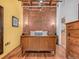 Bedroom featuring a brick wall, wood floors, and wood furniture at 2960 Inca St # 317, Denver, CO 80202