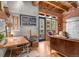 Office space boasts exposed brick walls, wood beams, and comfortable seating with an exterior view at 2960 Inca St # 317, Denver, CO 80202