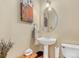 Traditional-style powder room with pedestal sink and vintage artwork at 2960 Inca St # 317, Denver, CO 80202