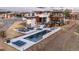 Stunning aerial view of modern home with pool, outdoor kitchen, dining, and lounging areas, perfect for entertaining at 5140 S Kearney Ct, Greenwood Village, CO 80111