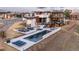 Aerial view of a modern home's backyard with a beautiful pool, patio, and lounge area perfect for outdoor entertaining at 5140 S Kearney Ct, Greenwood Village, CO 80111