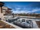 Backyard featuring an outdoor kitchen and spacious seating surrounding a fireplace, creating an inviting and relaxed atmosphere at 5140 S Kearney Ct, Greenwood Village, CO 80111