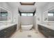 Elegant bathroom with double vanities, modern fixtures, soaking tub, and a bright window for natural light at 5140 S Kearney Ct, Greenwood Village, CO 80111