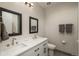 This modern bathroom boasts dual sinks, sleek fixtures, and a clean design, offering a serene and functional space at 5140 S Kearney Ct, Greenwood Village, CO 80111