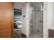 Modern bathroom featuring a glass-enclosed shower with stylish tiling, and a glimpse of a serene bedroom at 5140 S Kearney Ct, Greenwood Village, CO 80111