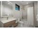 Modern bathroom with a large mirror, walk-in shower, and toilet at 5140 S Kearney Ct, Greenwood Village, CO 80111