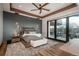 Bedroom is decorated with a plush bed, wood accents, and access to the outdoor living area at 5140 S Kearney Ct, Greenwood Village, CO 80111