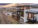 Stunning modern home features multiple balconies overlooking a sleek pool and picturesque mountain views at sunset at 5140 S Kearney Ct, Greenwood Village, CO 80111