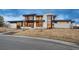 Modern luxury home with a flat roof, stone accents, and large windows for ample natural light at 5140 S Kearney Ct, Greenwood Village, CO 80111