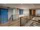 Modern hallway with wood floors, contemporary lighting, and sleek railings overlooking the lower level at 5140 S Kearney Ct, Greenwood Village, CO 80111