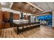 Modern kitchen with a large island, wooden cabinets, and an open layout flowing into the dining area at 5140 S Kearney Ct, Greenwood Village, CO 80111