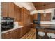 Spacious kitchen boasts wood cabinets, stainless steel appliances, and a breakfast bar at 5140 S Kearney Ct, Greenwood Village, CO 80111