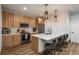 Modern kitchen with stainless steel appliances, light wood cabinets and quartz countertops with counter seating at 5140 S Kearney Ct, Greenwood Village, CO 80111