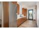 Modern kitchen with stainless steel appliances and wood cabinets by a door at 5140 S Kearney Ct, Greenwood Village, CO 80111