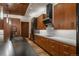 Modern kitchen features wood cabinetry, marble countertops, and a stylish black range hood at 5140 S Kearney Ct, Greenwood Village, CO 80111