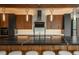 Kitchen island features dark countertops with seating and modern pendant lighting at 5140 S Kearney Ct, Greenwood Village, CO 80111