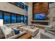 Elegant living room with high ceilings, stone fireplace, and large sliding glass doors to the outside at 5140 S Kearney Ct, Greenwood Village, CO 80111