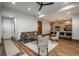 Open concept living room with hardwood floors and modern lighting that connects to the kitchen, perfect for entertaining at 5140 S Kearney Ct, Greenwood Village, CO 80111