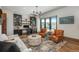 Bright home office with modern decor, built-in shelving, comfortable seating, and scenic outdoor views at 5140 S Kearney Ct, Greenwood Village, CO 80111