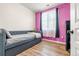 Bedroom with a daybed, pink walls, and wood-look floors at 833 E 98Th Ave # 204, Thornton, CO 80229