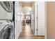 Hallway with laundry closet and view into living area at 833 E 98Th Ave # 204, Thornton, CO 80229