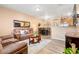 Spacious living room with brown leather furniture and hardwood floors at 833 E 98Th Ave # 204, Thornton, CO 80229