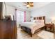 Main bedroom with a wooden bed frame and ceiling fan at 833 E 98Th Ave # 204, Thornton, CO 80229