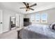 Bedroom with large bed, ceiling fan, dresser, and bright windows with scenic views at 21413 E 59Th Pl, Aurora, CO 80019