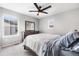 Bright bedroom with natural light, wooden dresser, ceiling fan, and warm carpet at 21413 E 59Th Pl, Aurora, CO 80019