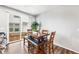 Bright dining room with wood table, bench seating, and sliding glass doors to an outdoor patio at 21413 E 59Th Pl, Aurora, CO 80019