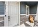Cozy front porch features a comfortable chair, stylish stone accents, and a welcoming entrance at 21413 E 59Th Pl, Aurora, CO 80019