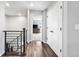 Upstairs hallway with wood floors and natural light leading to bedrooms and other rooms at 21413 E 59Th Pl, Aurora, CO 80019